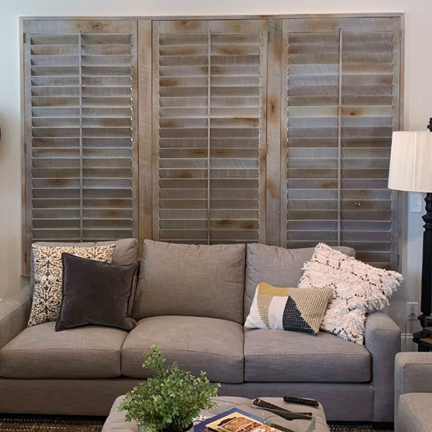 Reclaimed wood shutters above a couch