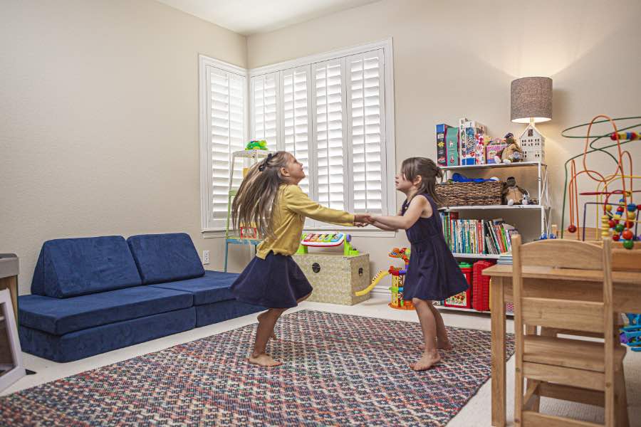 Choose Polywood shutters for durable, kid-friendly great room window treatments in Cleveland. Polywood shutters on multiple windows in a sitting area