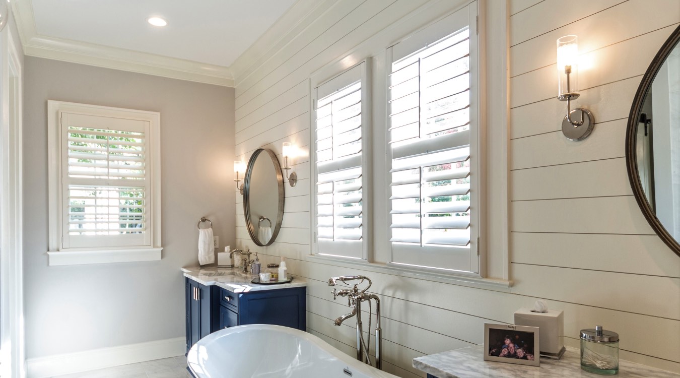 Cleveland bathroom with white plantation shutters.