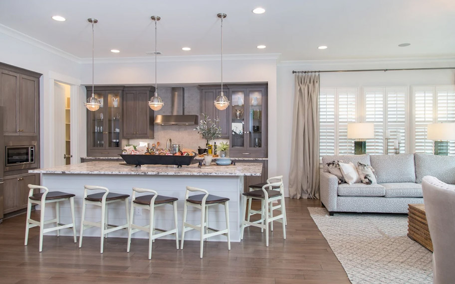 Illuminate your home with custom interior shutters in Cleveland. White arched shutters in a white kitchen with lots of light.