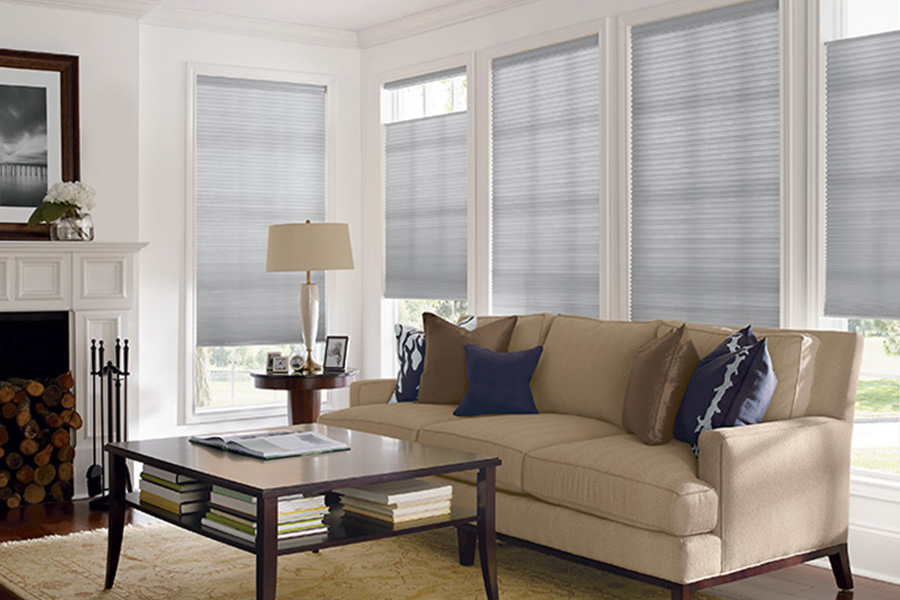 Gray window blinds on windows in a neutral living room