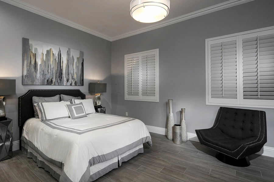 Close your custom Polywood shutters to beat the heat and keep your Cleveland bedroom cool. White Polywood shutters on bedroom windows