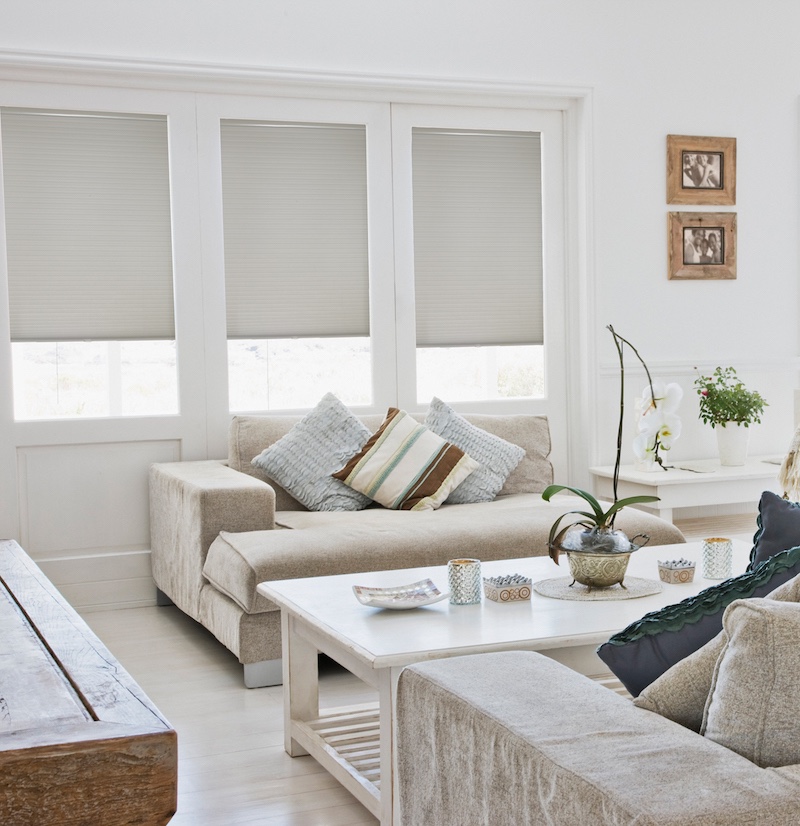 Cell shades in an airy living room