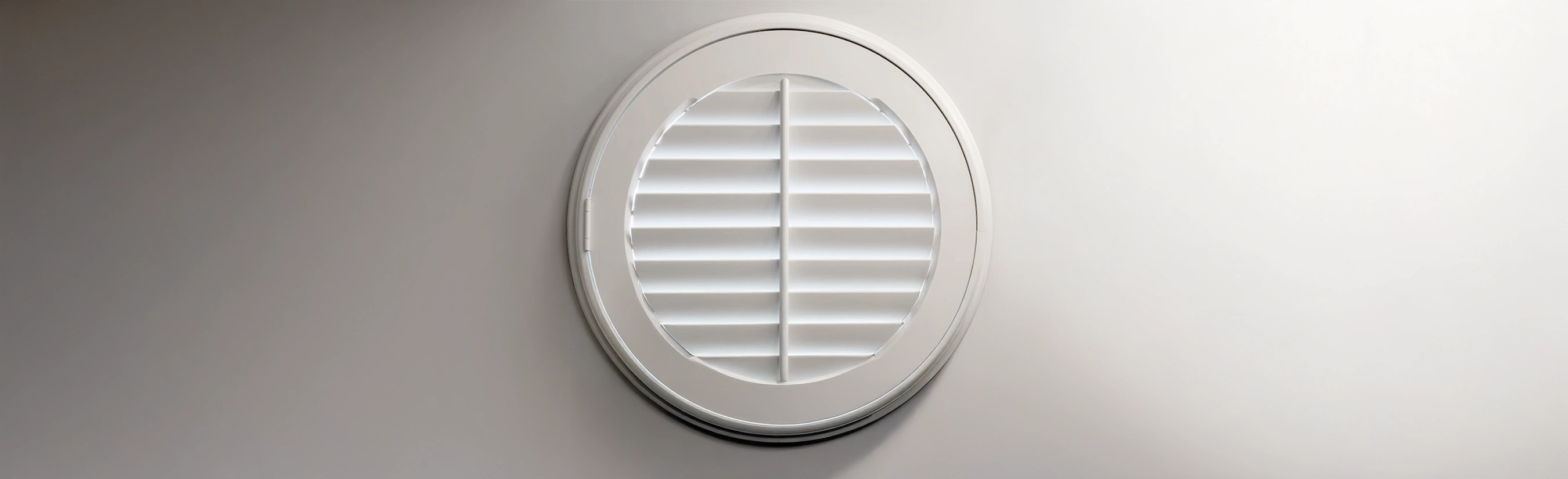 White circle shutter on a wall close up.