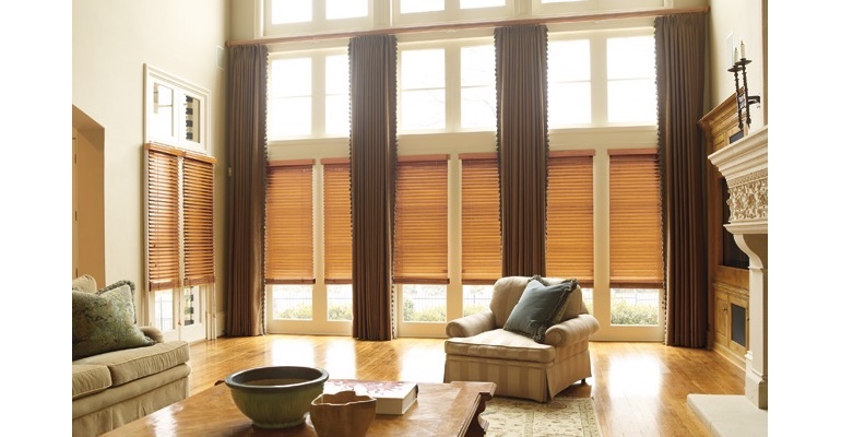 Cleveland great room with wooden blinds and full-length draperies. Cleveland great room with wooden blinds and full-length draperies.
