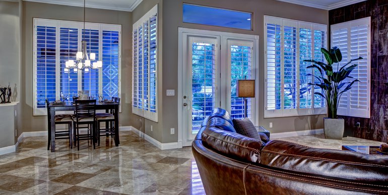 Photo Courtesy of Room Resolutions Cleveland great room with plantation shutters and modern lighting.