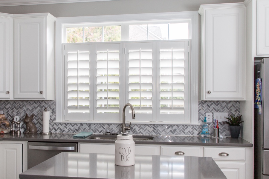 Classic Polywood interior shutters in Cleveland are moisture-resistant. White Polywood shutters above a kitchen sink