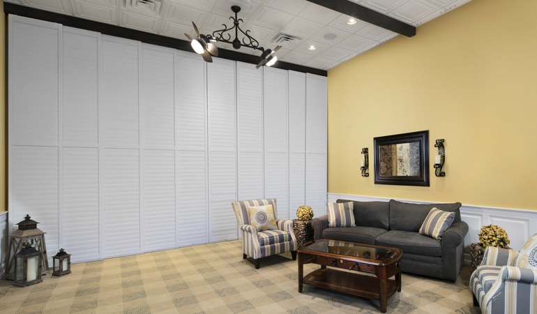 Interior shutteres can be used on as a room divider. Plantation shutters as a room divider for a business