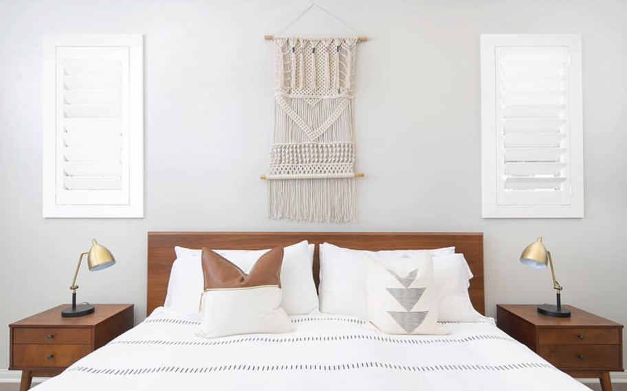 Custom-fitted louvered shutters provide excellent nighttime privacy in Cleveland. Photo Credit: Audrey Crisp Louvered shutters in a bedroom.
