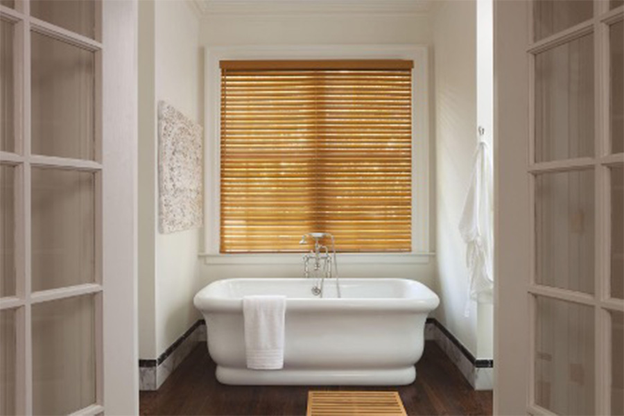 Faux wood blinds add a bit of flair along with water-resistance for your bathroom window treatments faux wood blinds above a tub