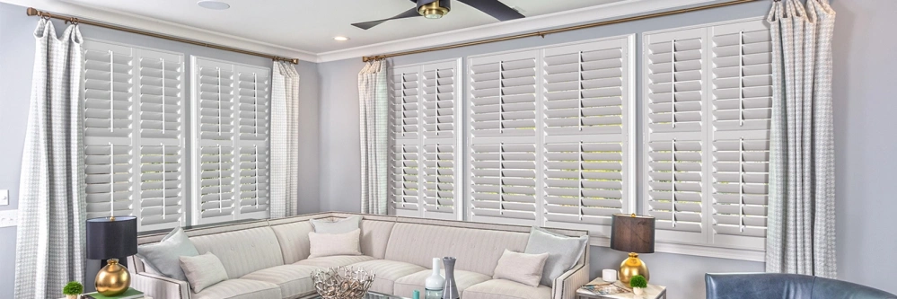 White Polywood plantation shutters on living room windows